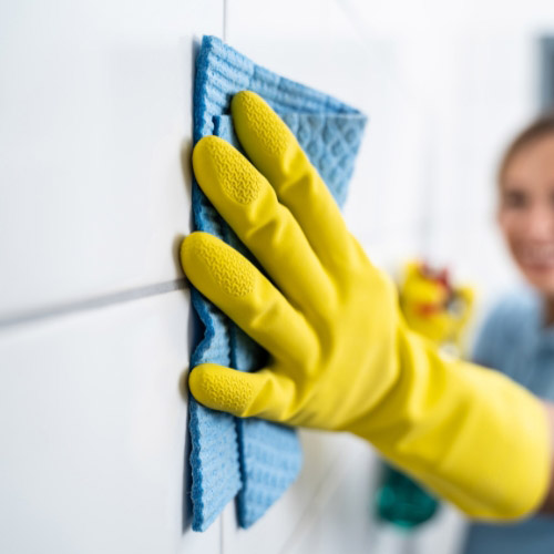 person cleaning the wall